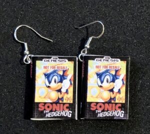 The Sonic the hedgehog cover miniature earrings with fishhook earring backs displayed on a black background.